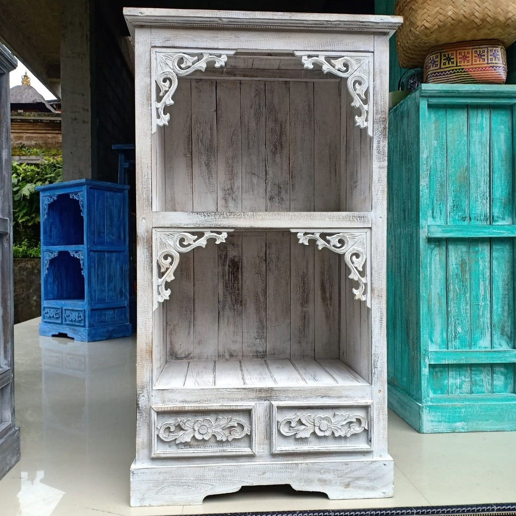 Wooden cabinet with intricate carvings in a rustic setting
