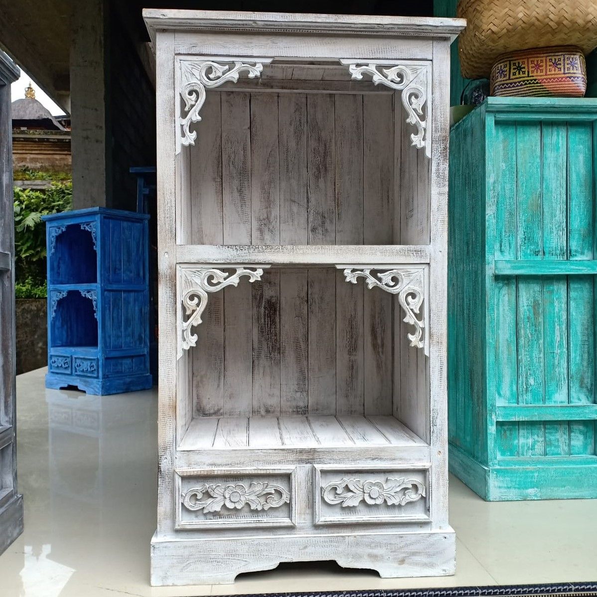 Wooden cabinet with intricate carvings in a rustic setting