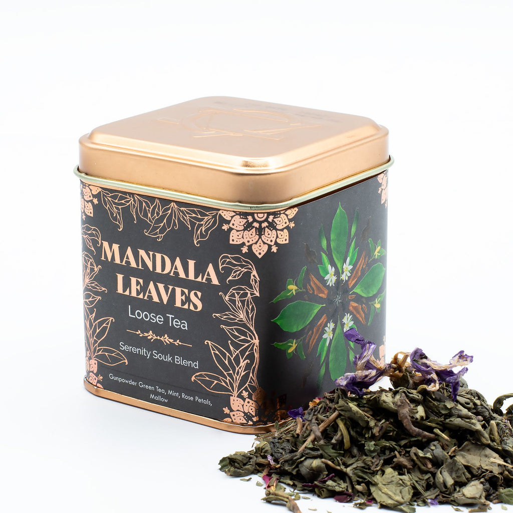 Tea canister labeled 'Mandala Leaves' with loose tea leaves on a white background