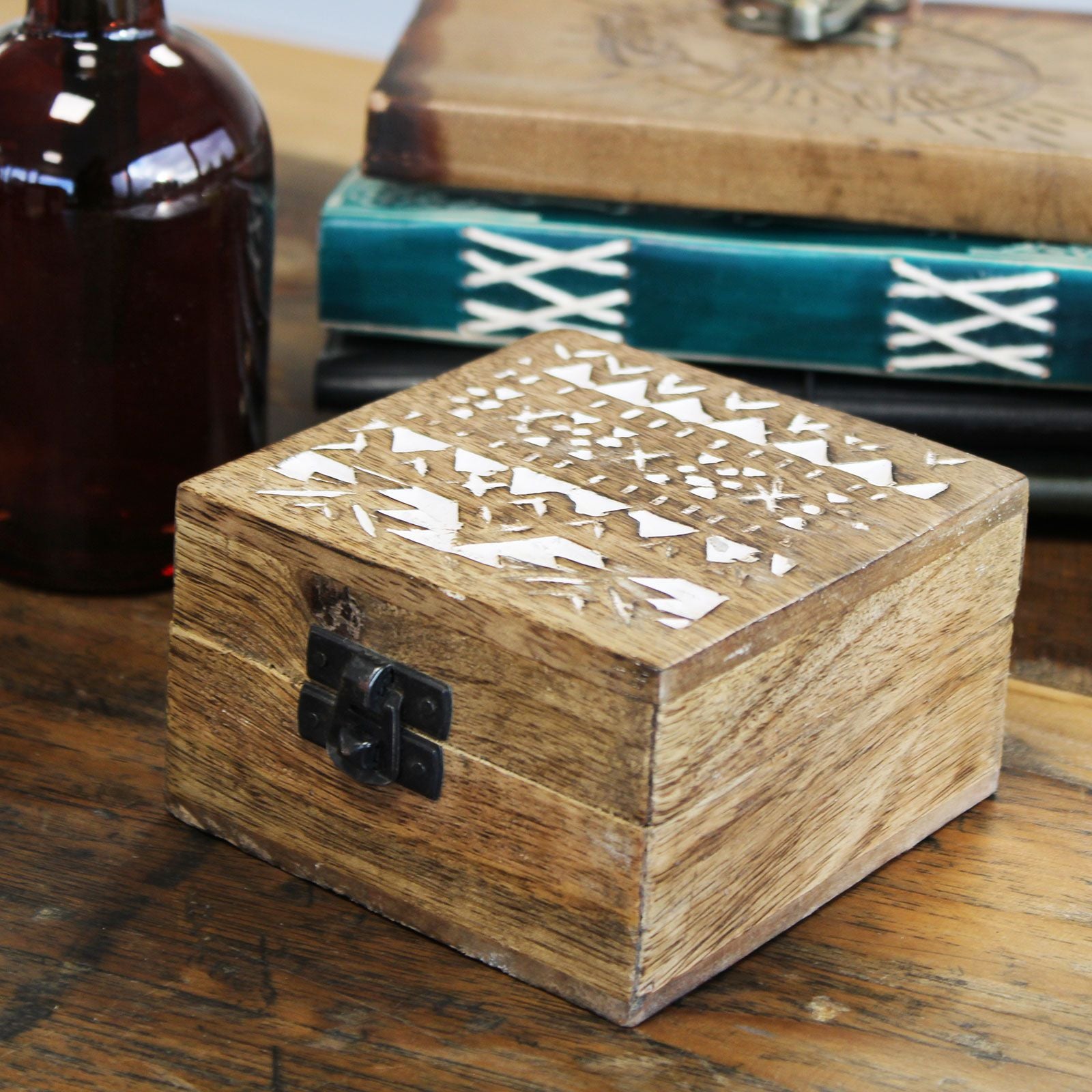 Wooden box with geometric patterns on a wooden surface