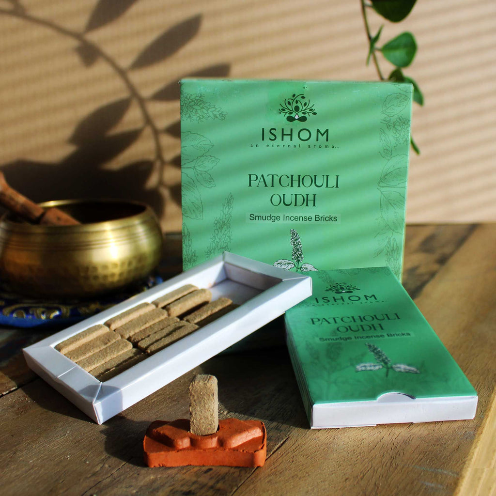 Ishom Patchouli Oudh incense bricks with packaging on a wooden surface.