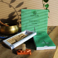 Ishom Patchouli Oudh incense bricks with packaging on a wooden surface.
