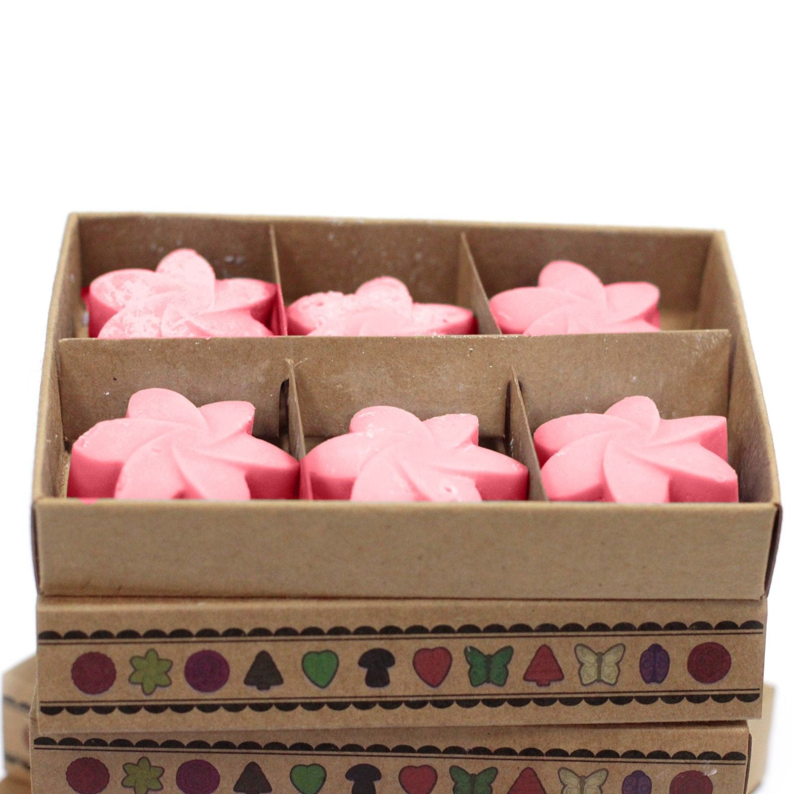 Box of pink flower-shaped objects on a white background