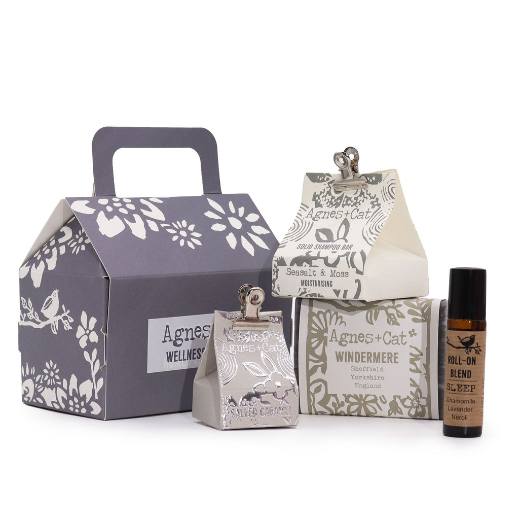 Collection of Agnes + Cat wellness products including a box, bottle, and other packaging on a white background.