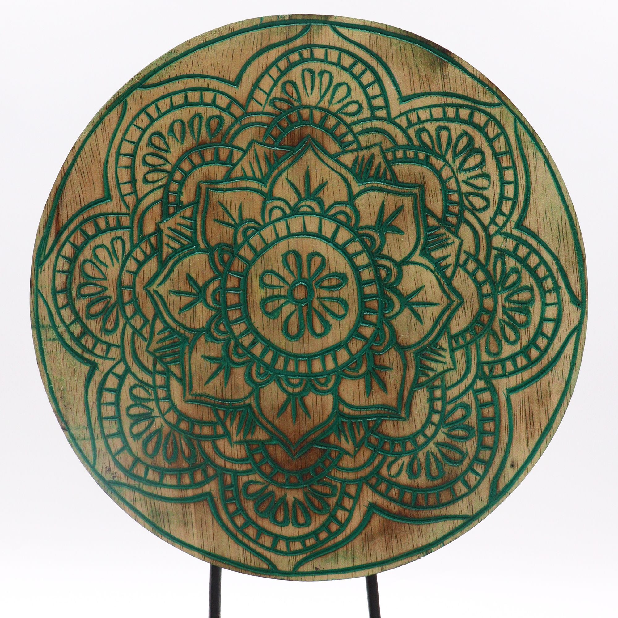 Wooden circular table with green mandala design on a white background