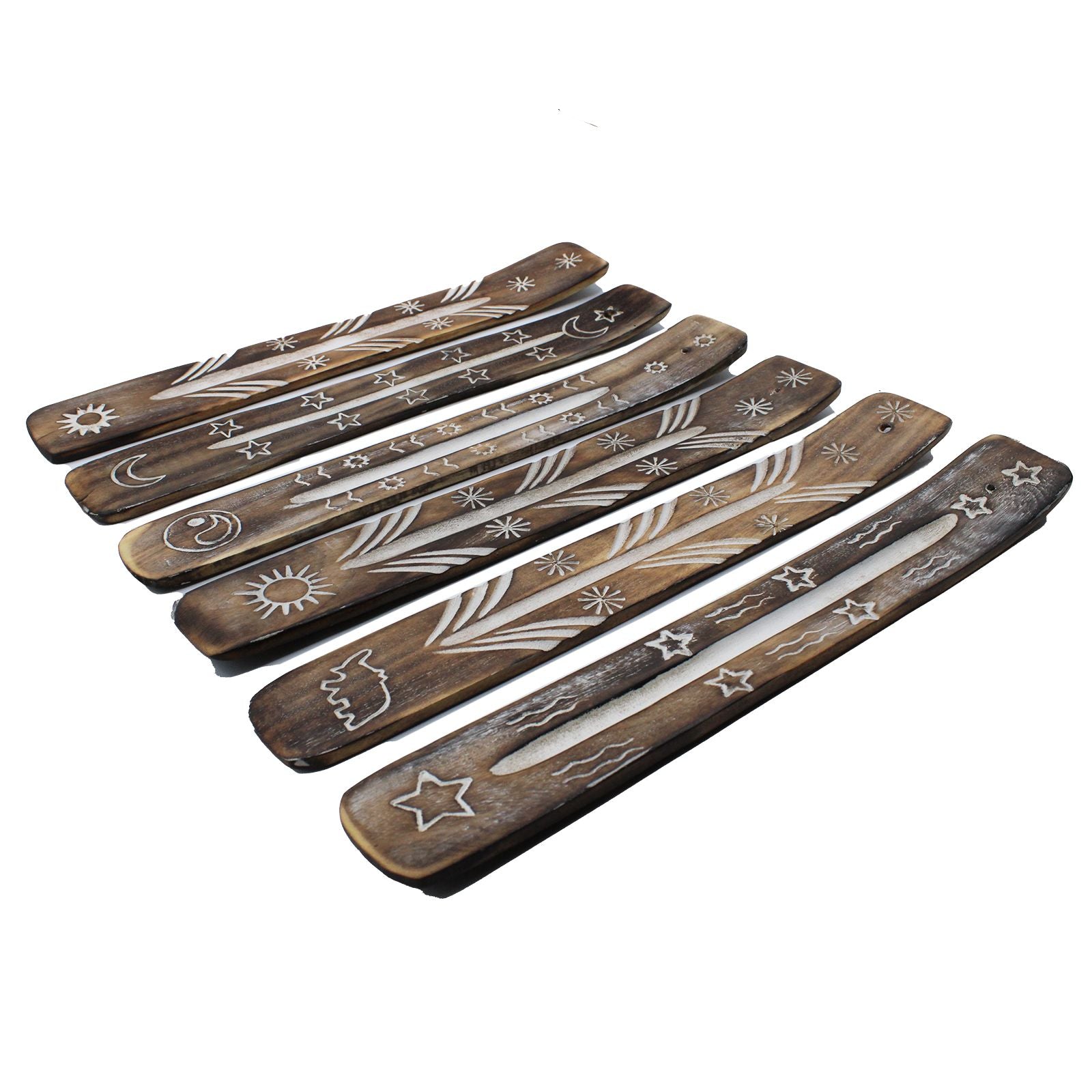 Set of wooden incense sticks with engraved designs on a white background