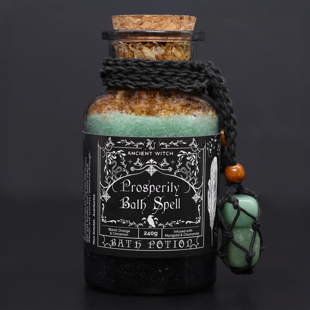 Bottle of 'Prosperity Bath Spell' bath potion with decorative label on a dark background