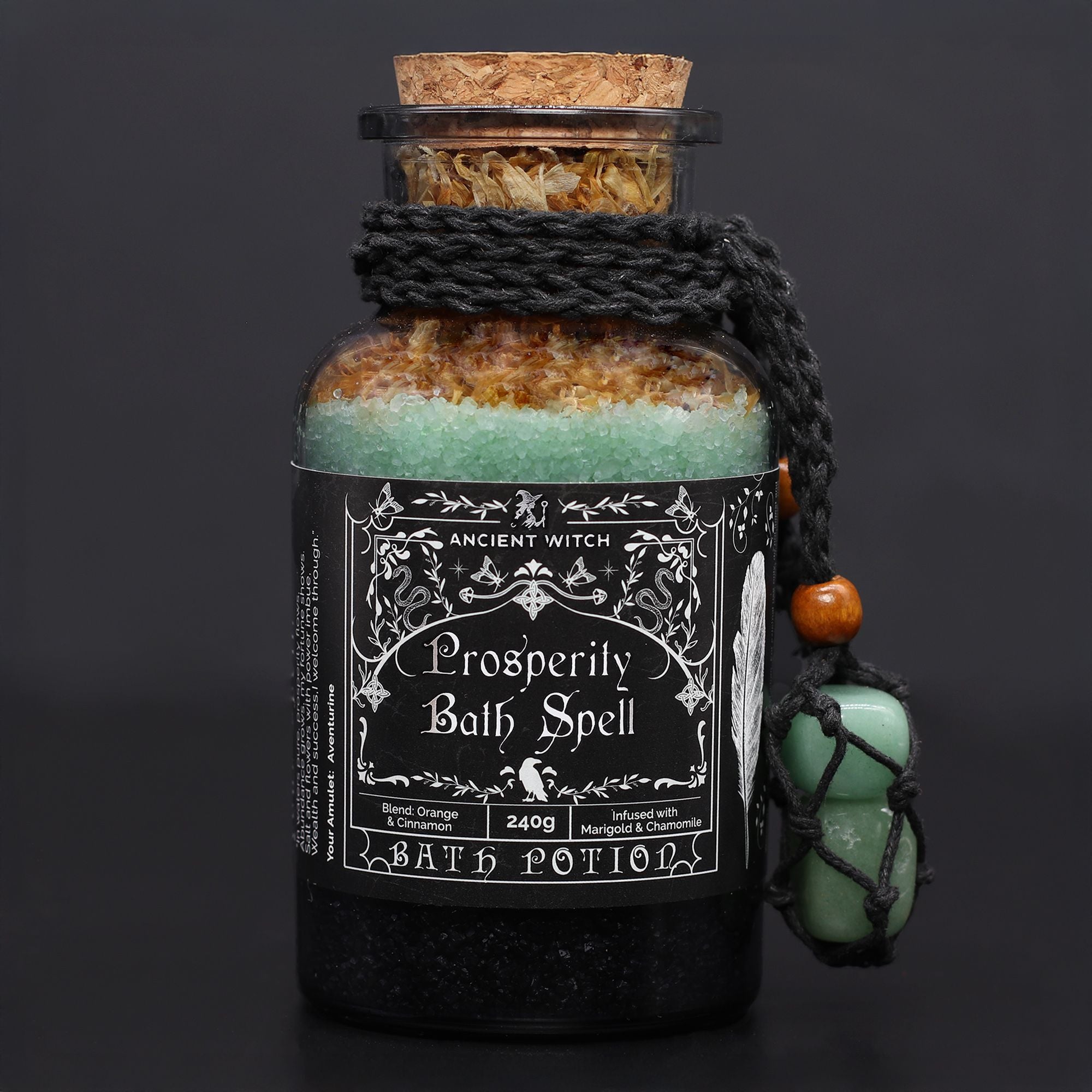 Bottle of 'Prosperity Bath Spell' bath potion with decorative label on a dark background