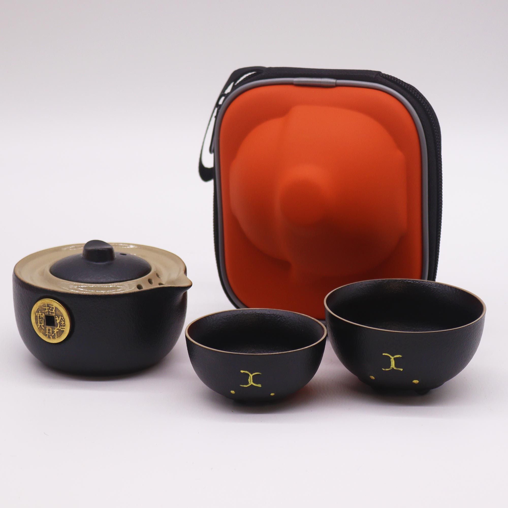 Black tea set with a carrying case on a white background