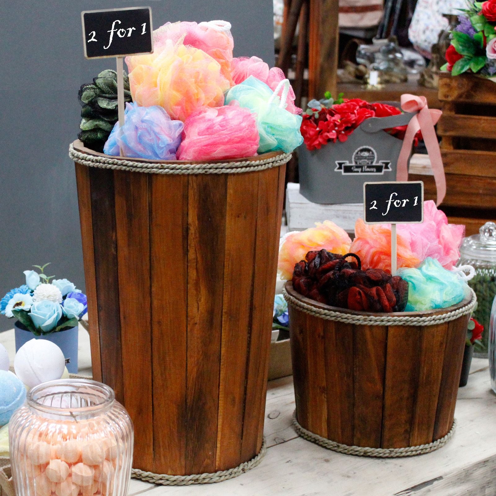 Wooden baskets filled with colorful bath bombs on a table.