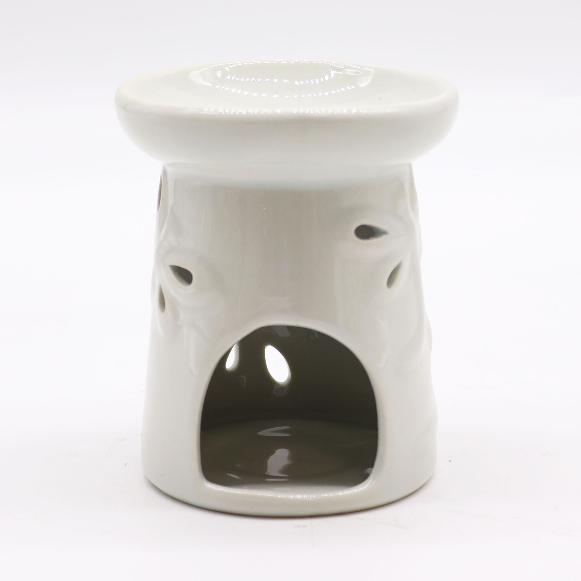 White ceramic oil burner with a white background
