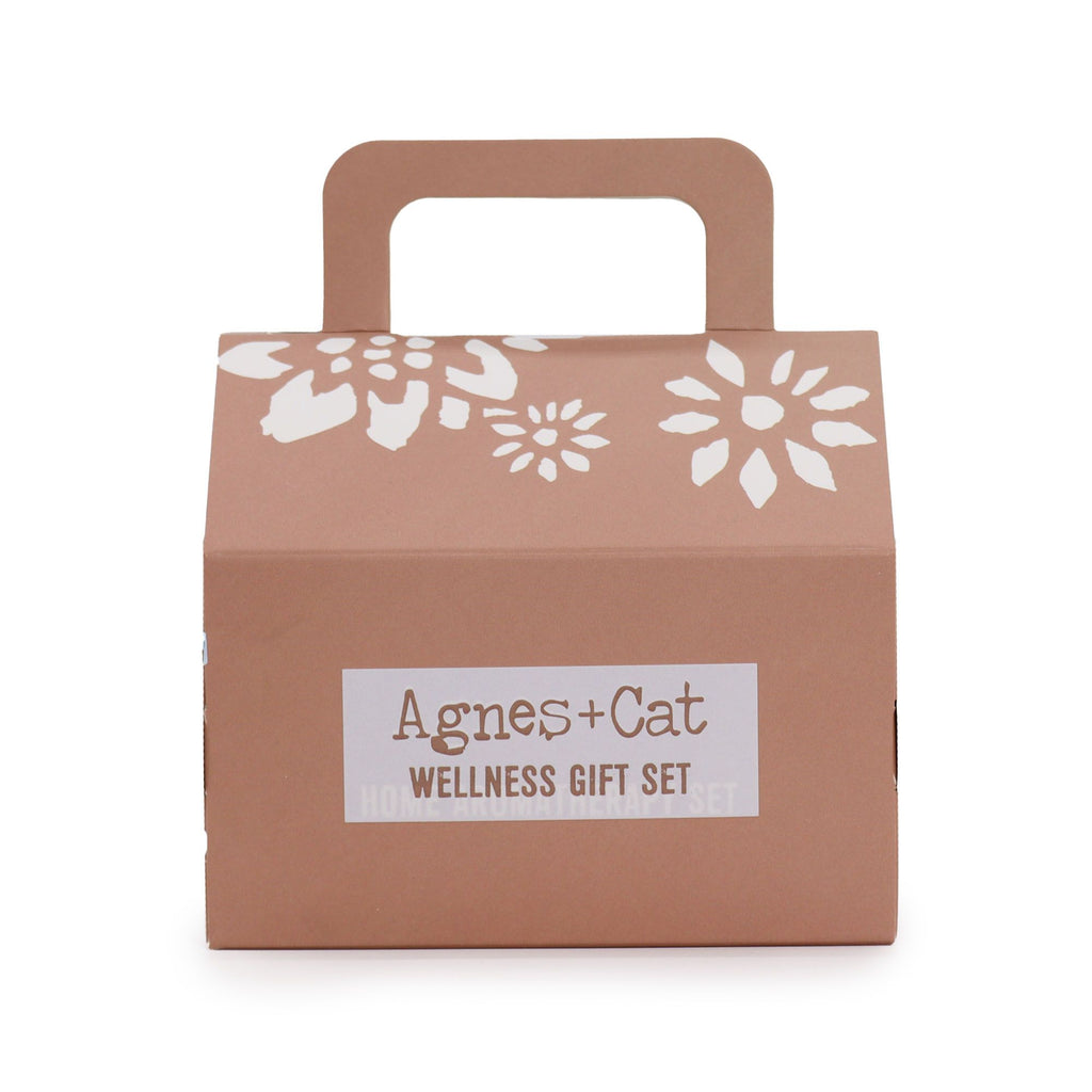 Brown gift box with floral design and 'Agnes + Cat Wellness Gift Set' label on a white background
