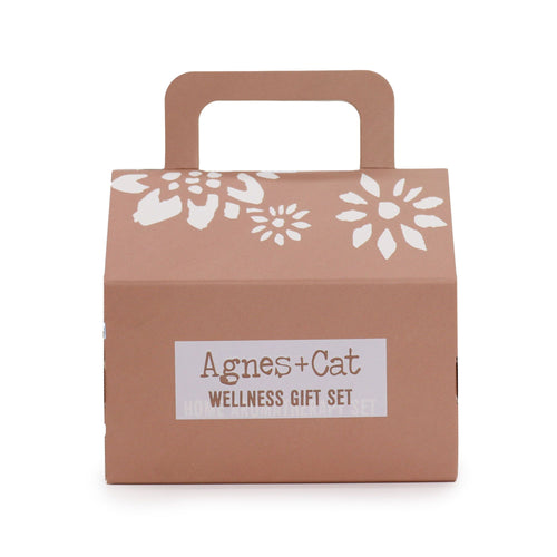 Brown gift box with floral design and 'Agnes + Cat Wellness Gift Set' label on a white background