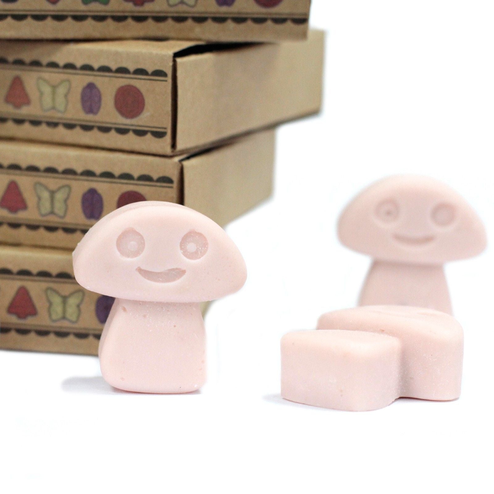 Two pink mushroom-shaped stamps with a smiley face design on a white background.