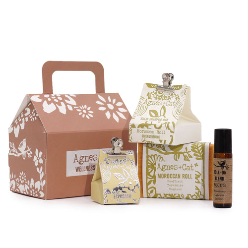 Collection of Agnes + Cat wellness products including a box, bottle, and pouches on a white background.