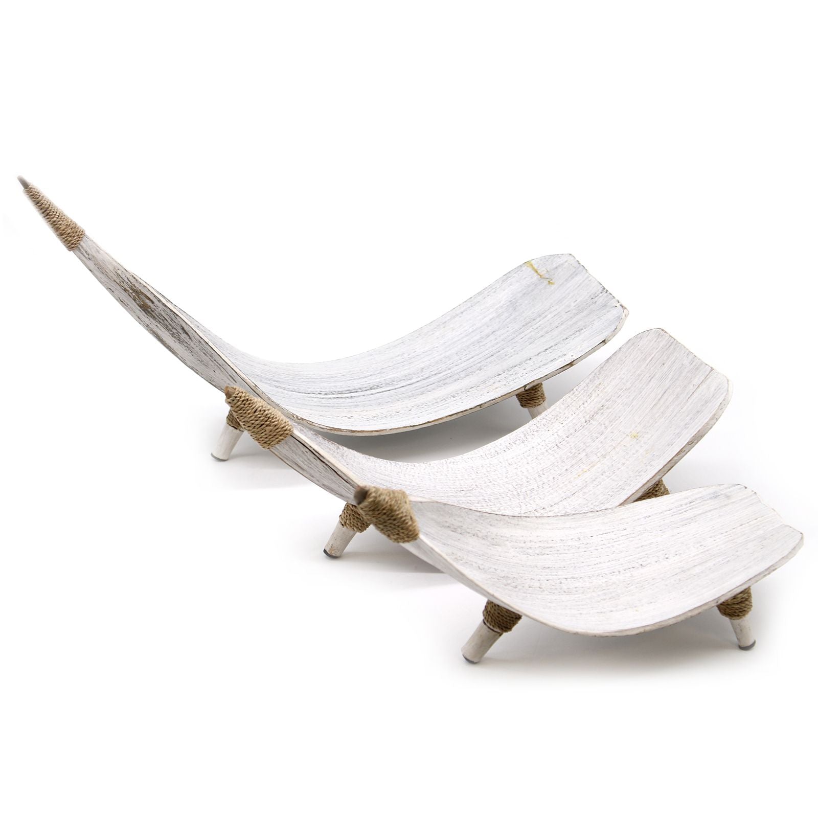 Set of three white ceramic shoes with gold accents on a white background