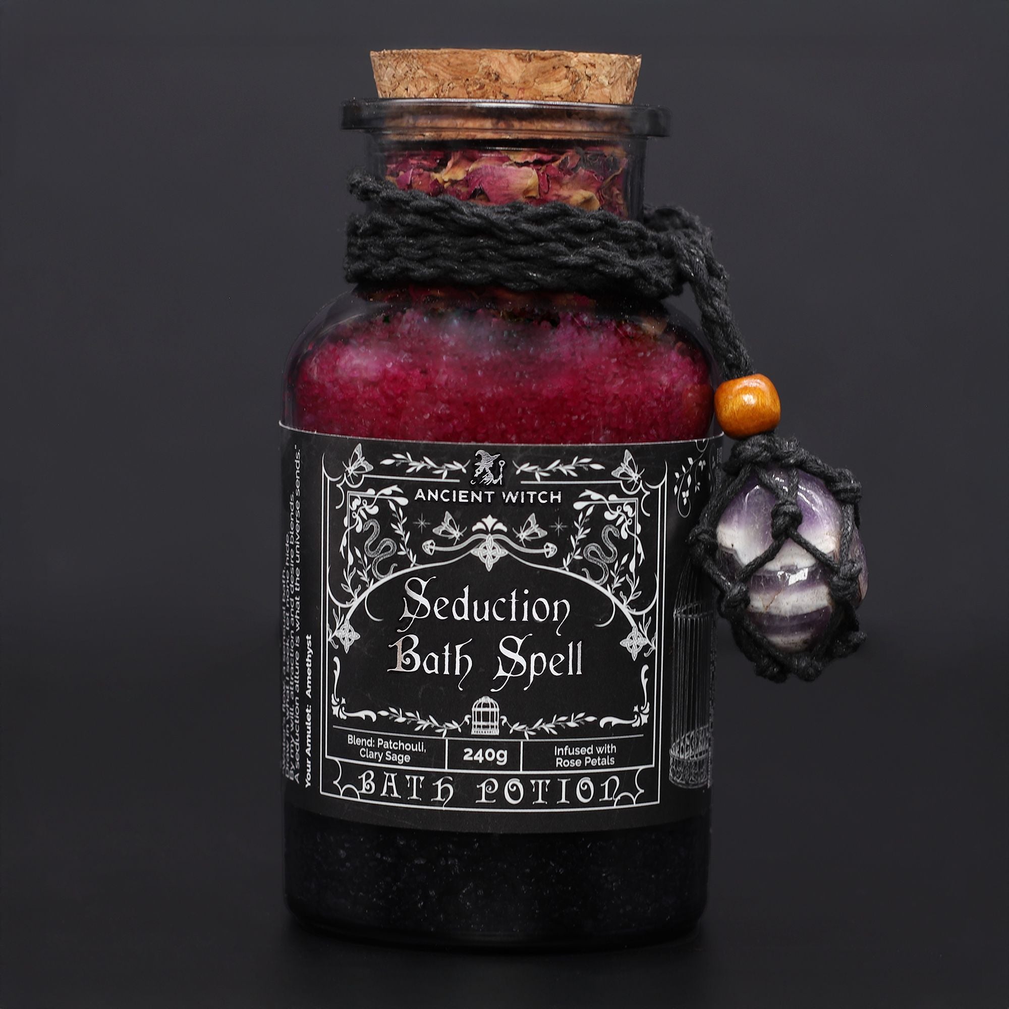 Bottle labeled 'Seduction Bath Spell' with decorative elements on a dark background