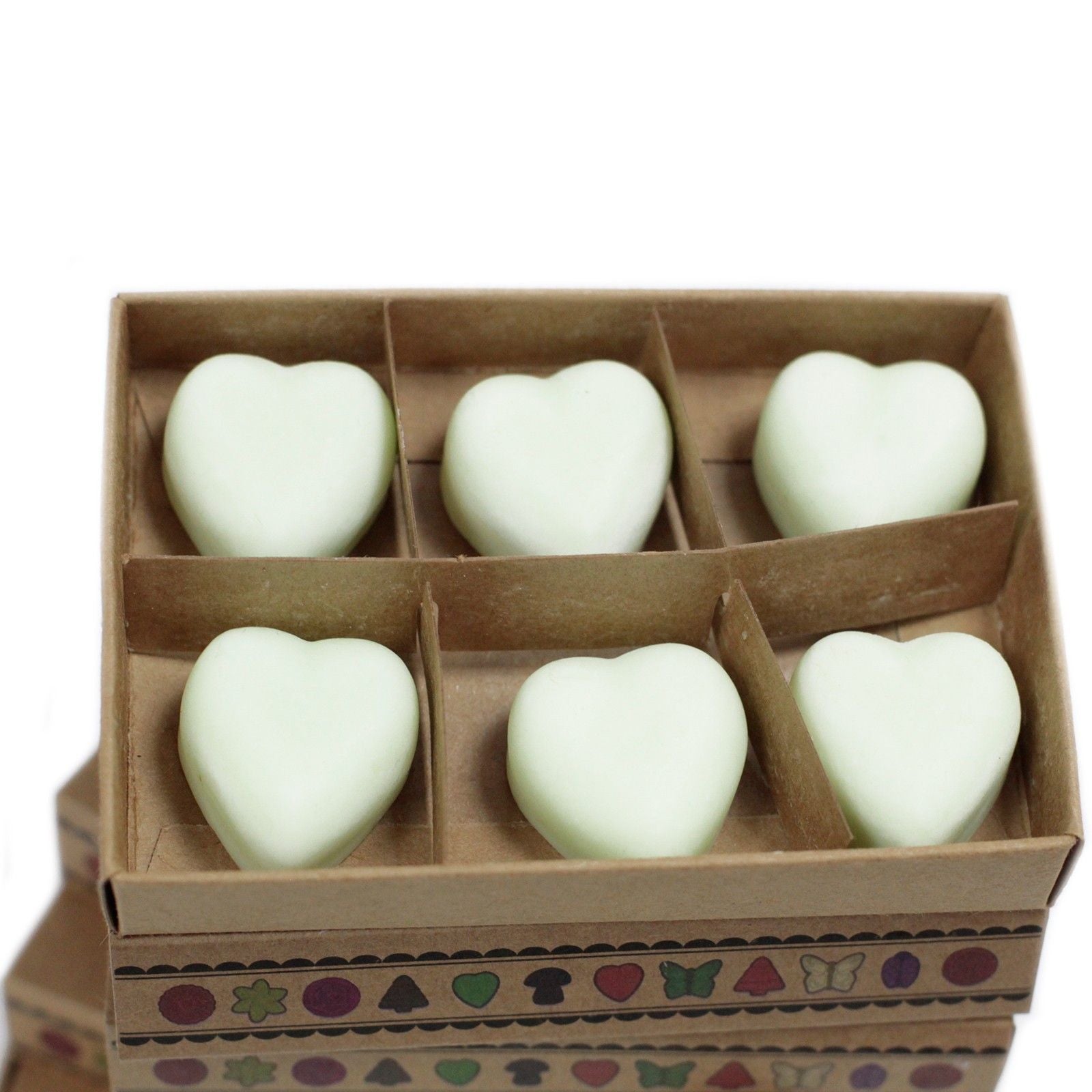 Heart-shaped white objects in a cardboard box with decorative patterns on a white background