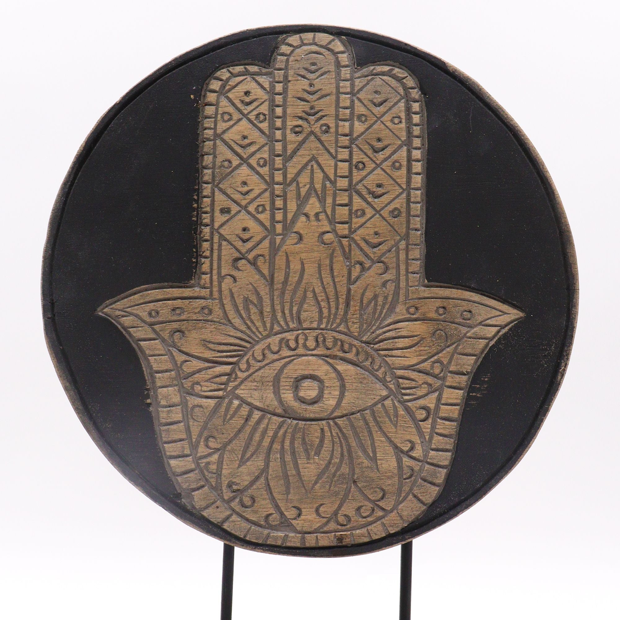 Decorative plate with Hamsa hand design on a black background