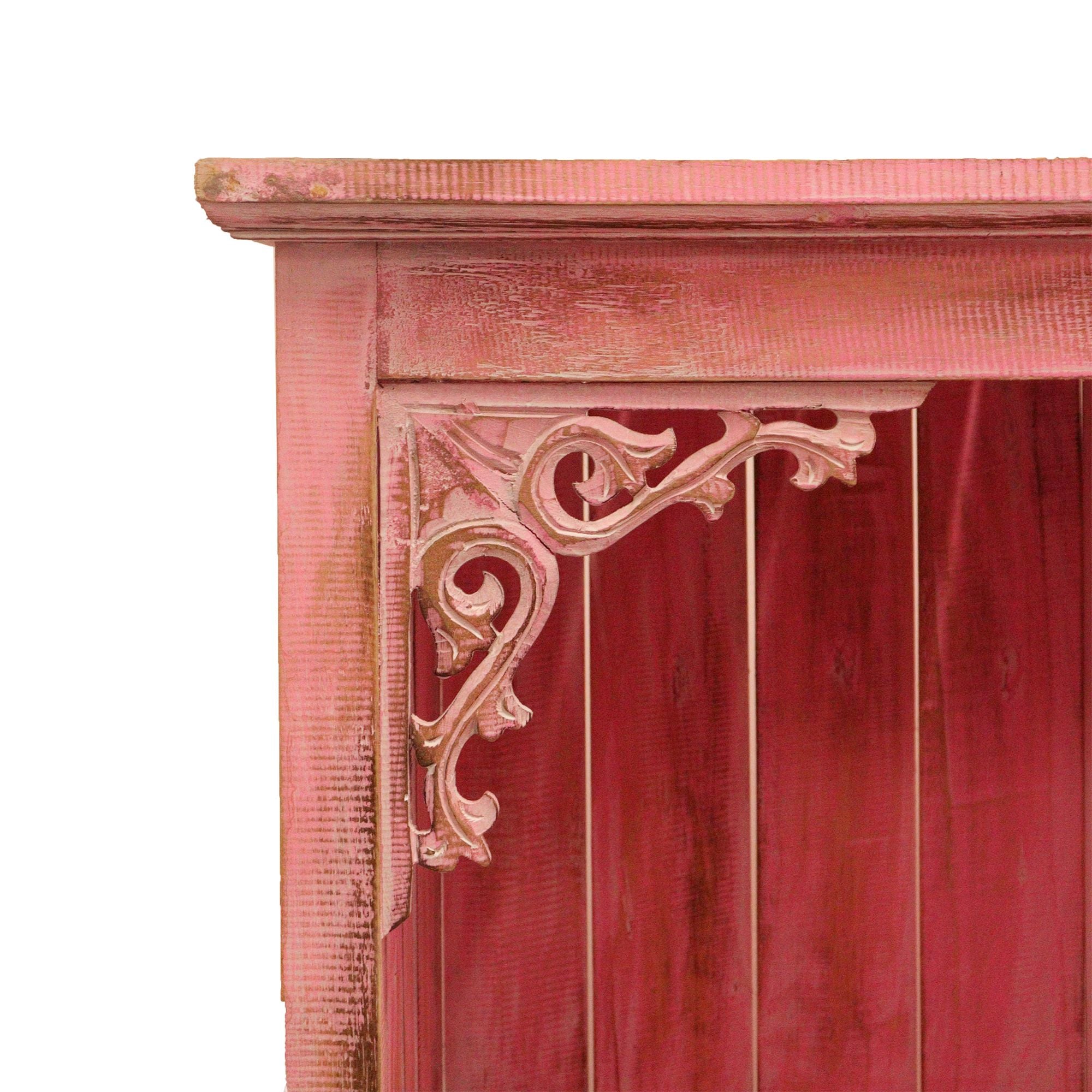 Close-up of a wooden cabinet with decorative carvings on a white background
