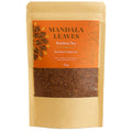 Tea package with 'Mandala Leaves' branding on an orange label