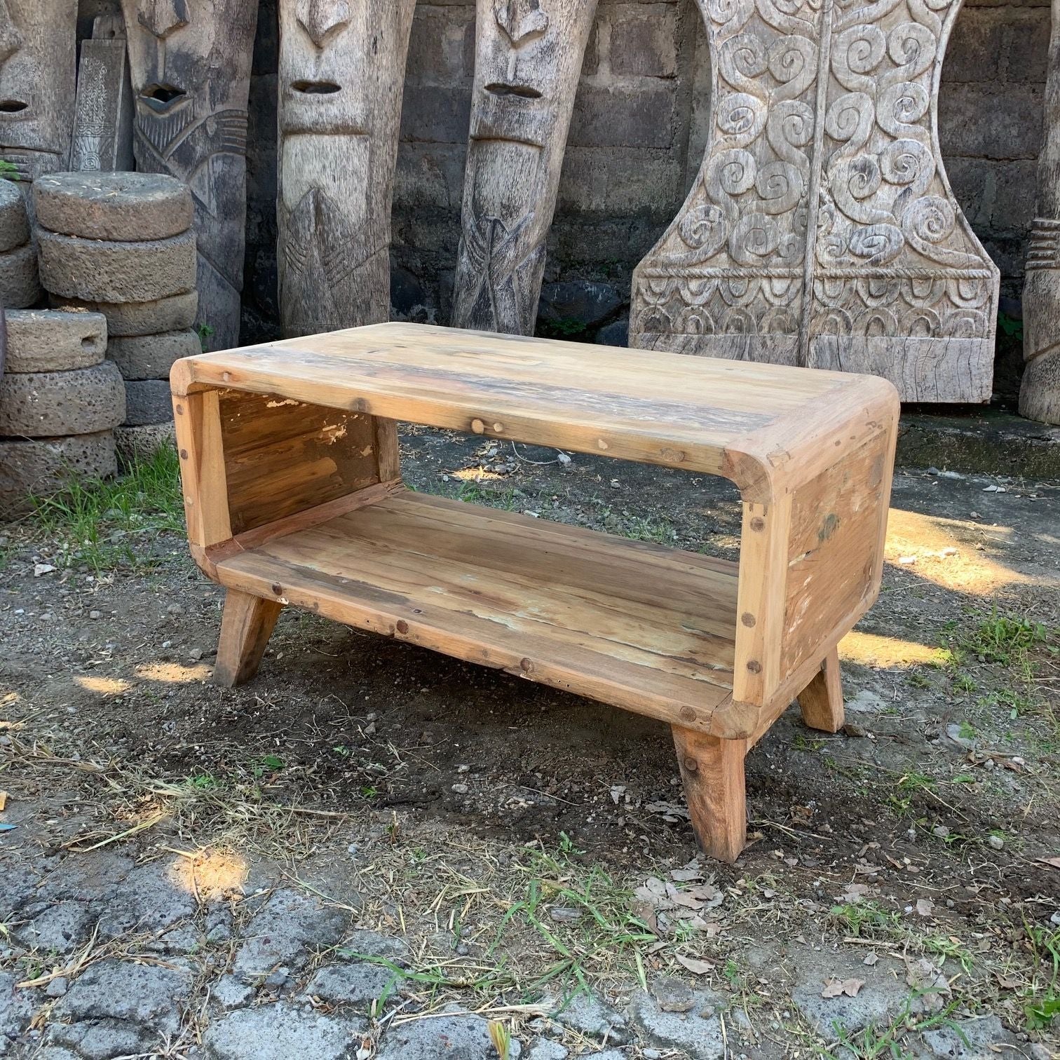 Wooden bench in front of stone carvings on a natural setting