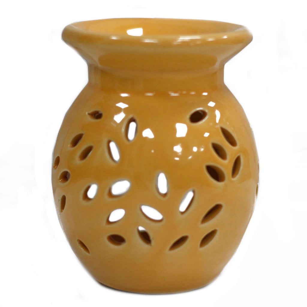 Yellow ceramic oil burner with perforated design on a white background