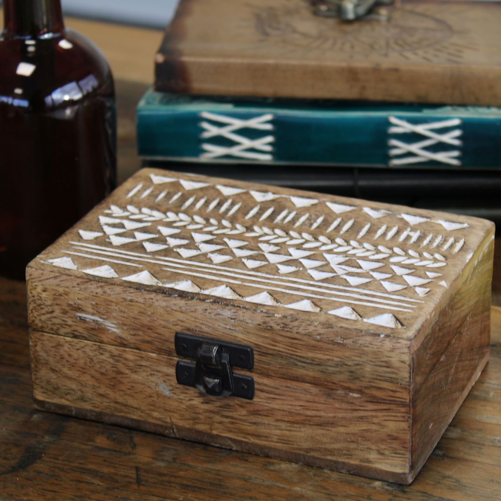 Wooden box with geometric patterns on a wooden surface