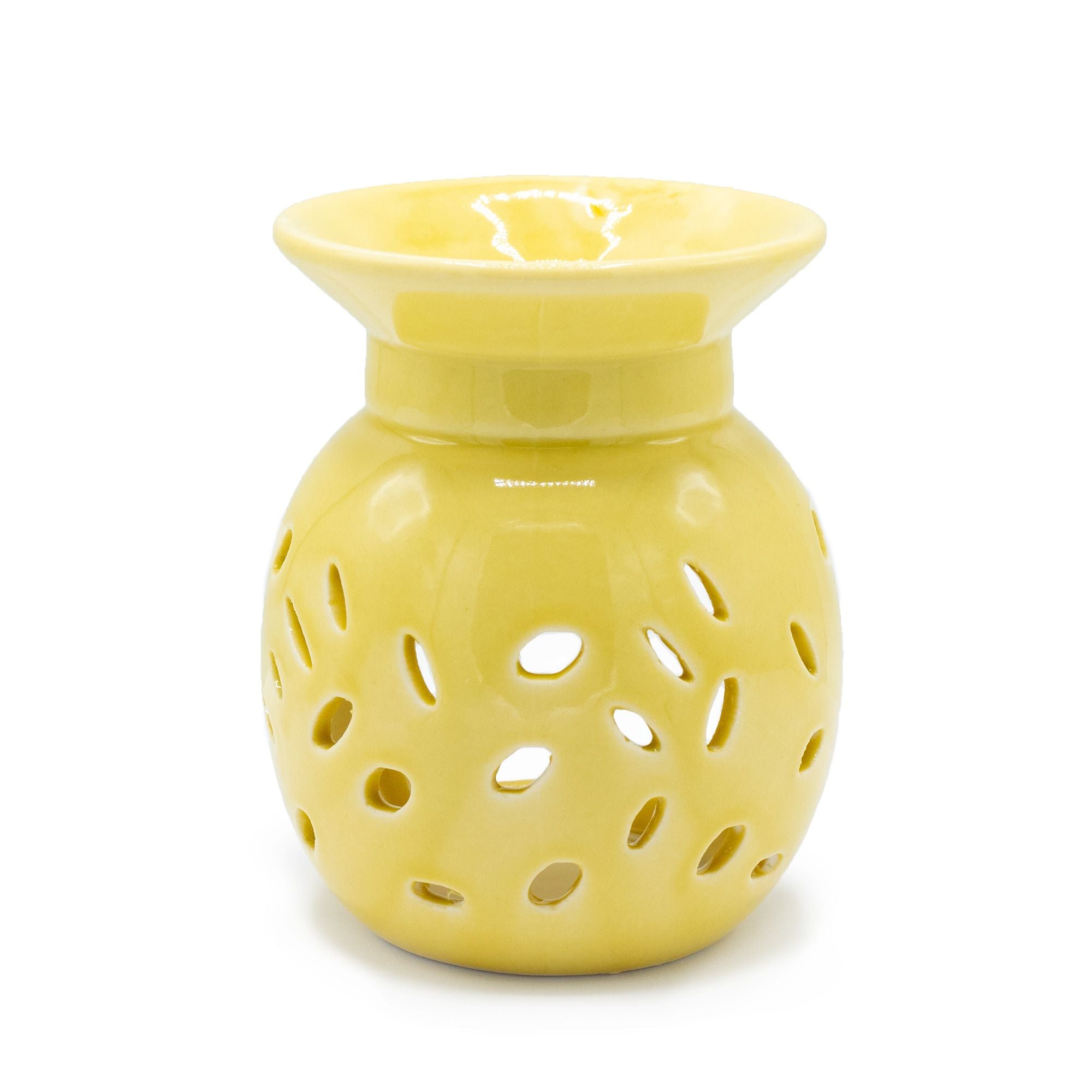 Yellow ceramic oil burner with perforated design on a white background