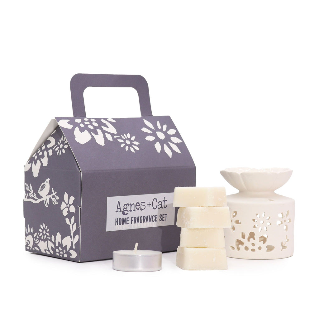Home fragrance set with a decorative box, candles, and a diffuser on a white background