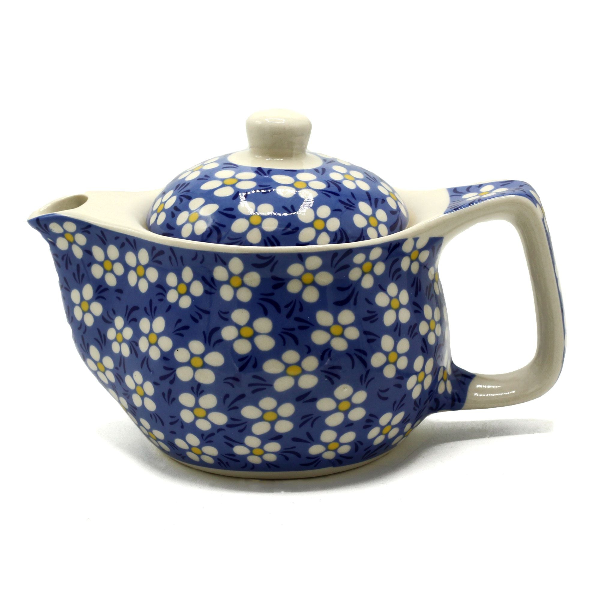 Ceramic teapot with floral pattern on a white background