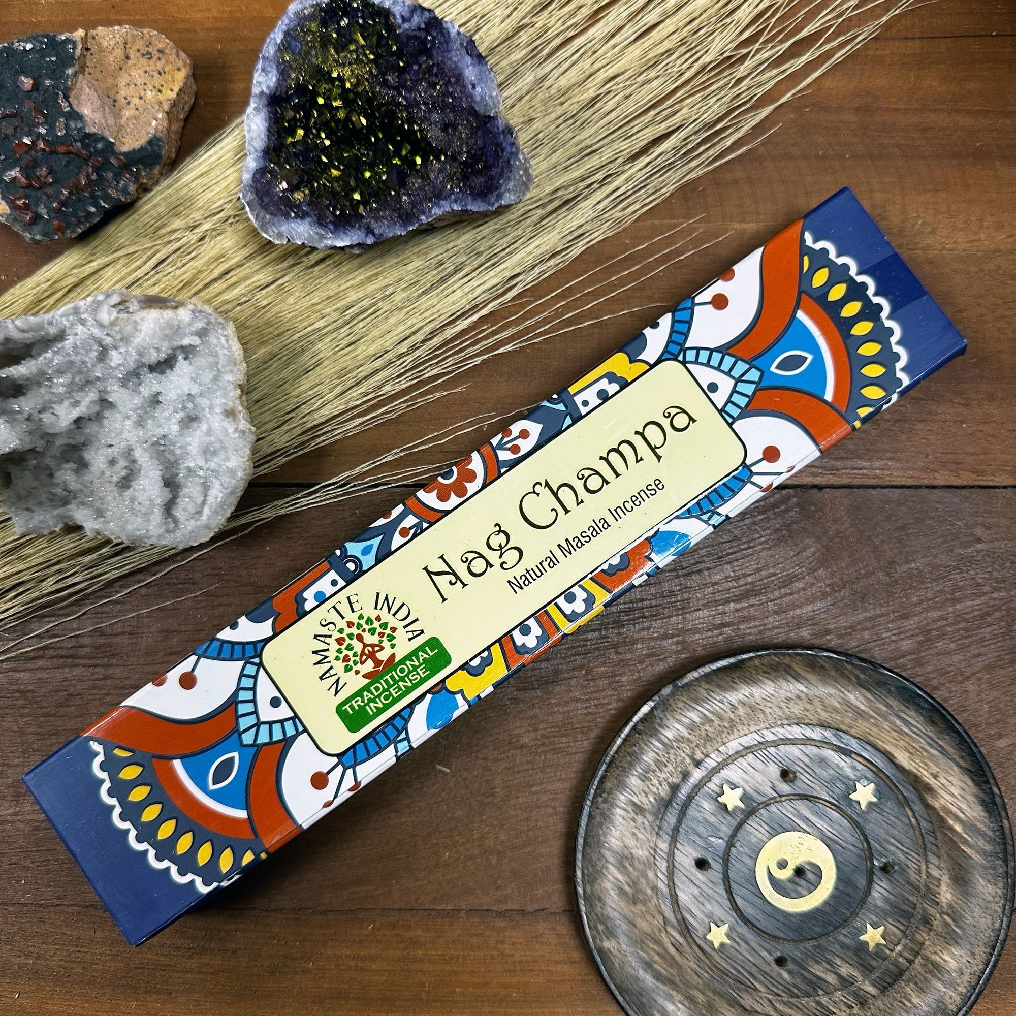 Nag Champa incense stick box with decorative elements on a wooden surface