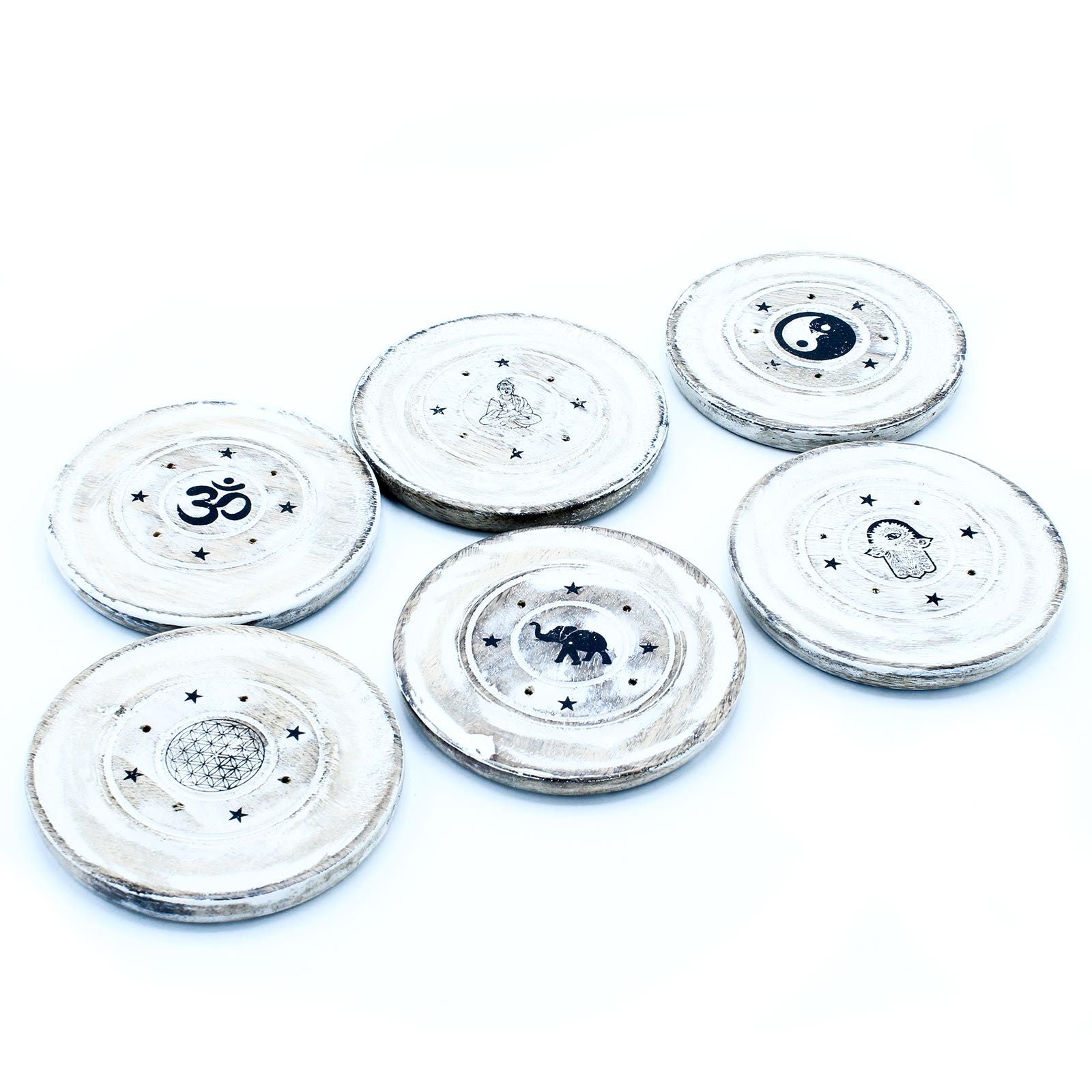 Set of six round stone coasters with various symbols on a white background