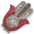 Decorative wall art piece with red, silver, and turquoise patterns on a white background
