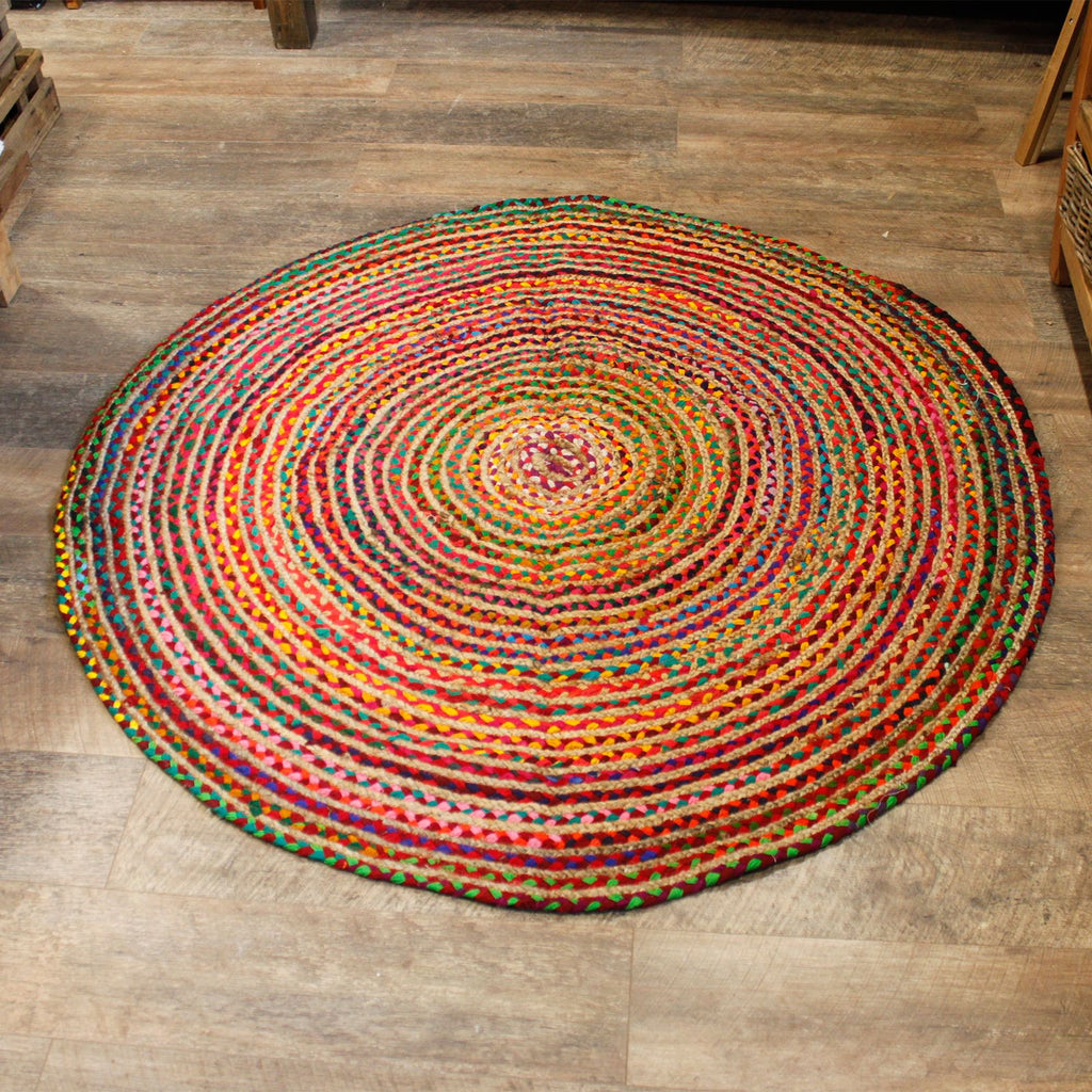 Multicolored circular rug on a wooden floor