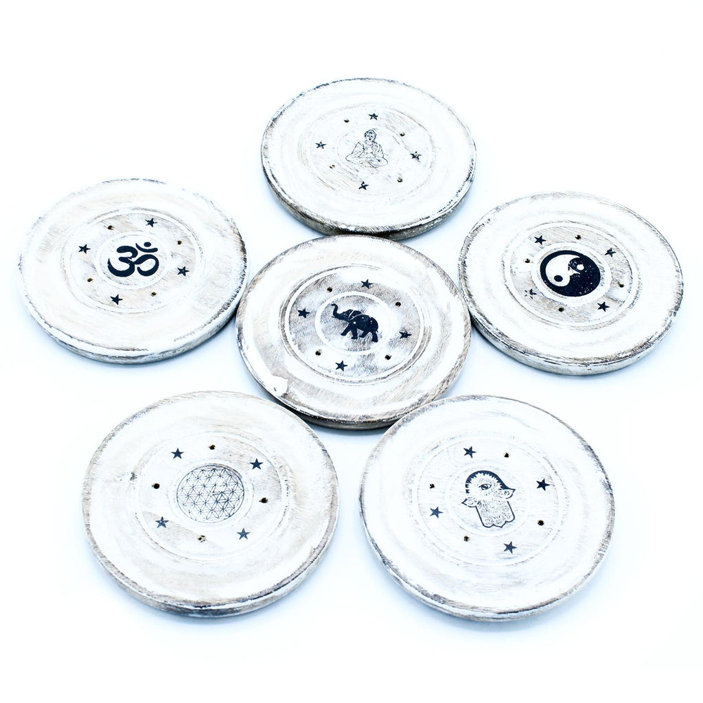 Set of six white coasters with black symbols on a white background