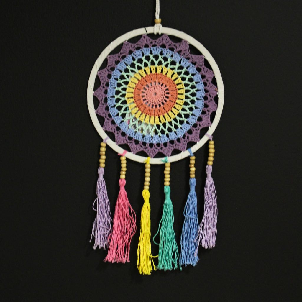 Colorful dreamcatcher with tassels on a black background
