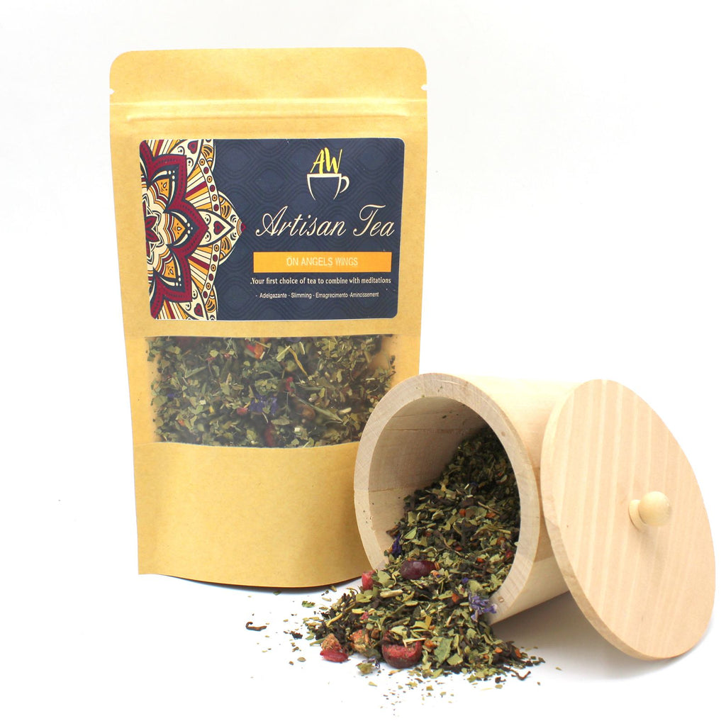 Tea packaging with a wooden scoop containing tea leaves on a white background
