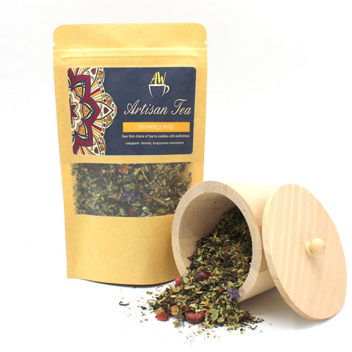Tea packaging with a wooden scoop containing tea leaves on a white background