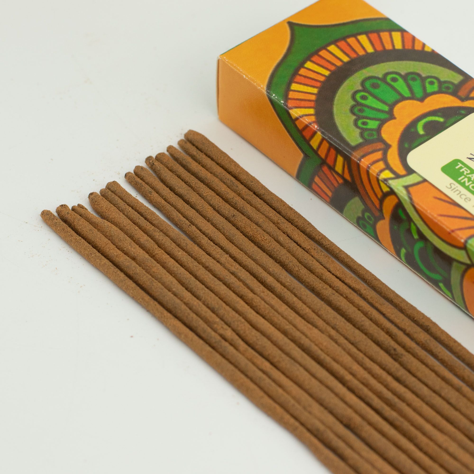 Incense sticks with a colorful box on a white background
