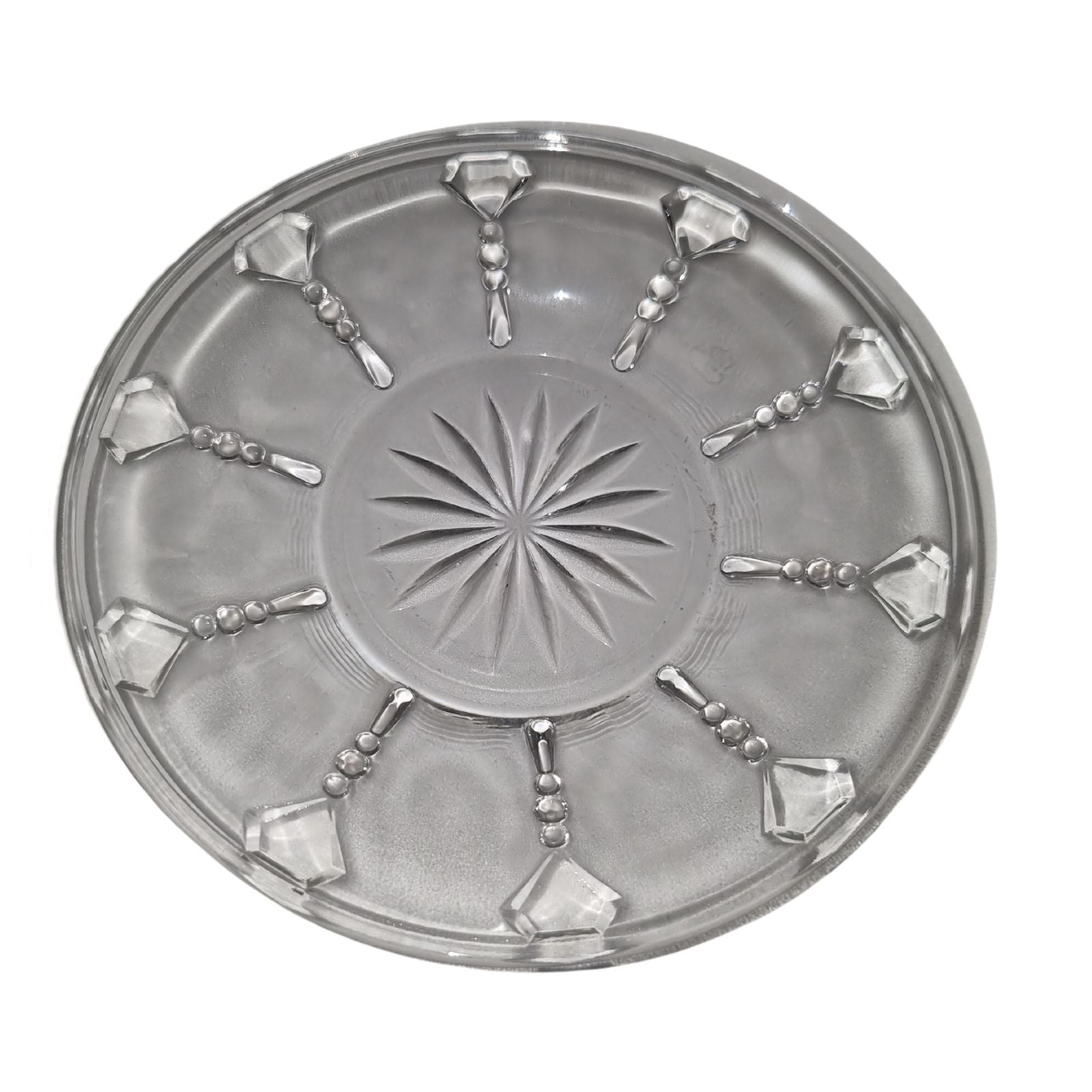 Decorative round metal tray with starburst design and geometric patterns on a white background