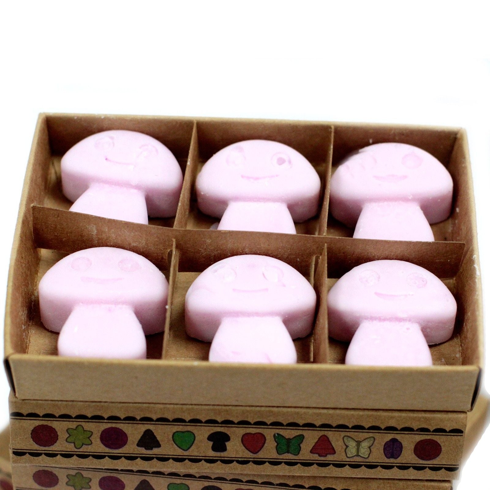 Box of pink mushroom-shaped bath bombs on a white background