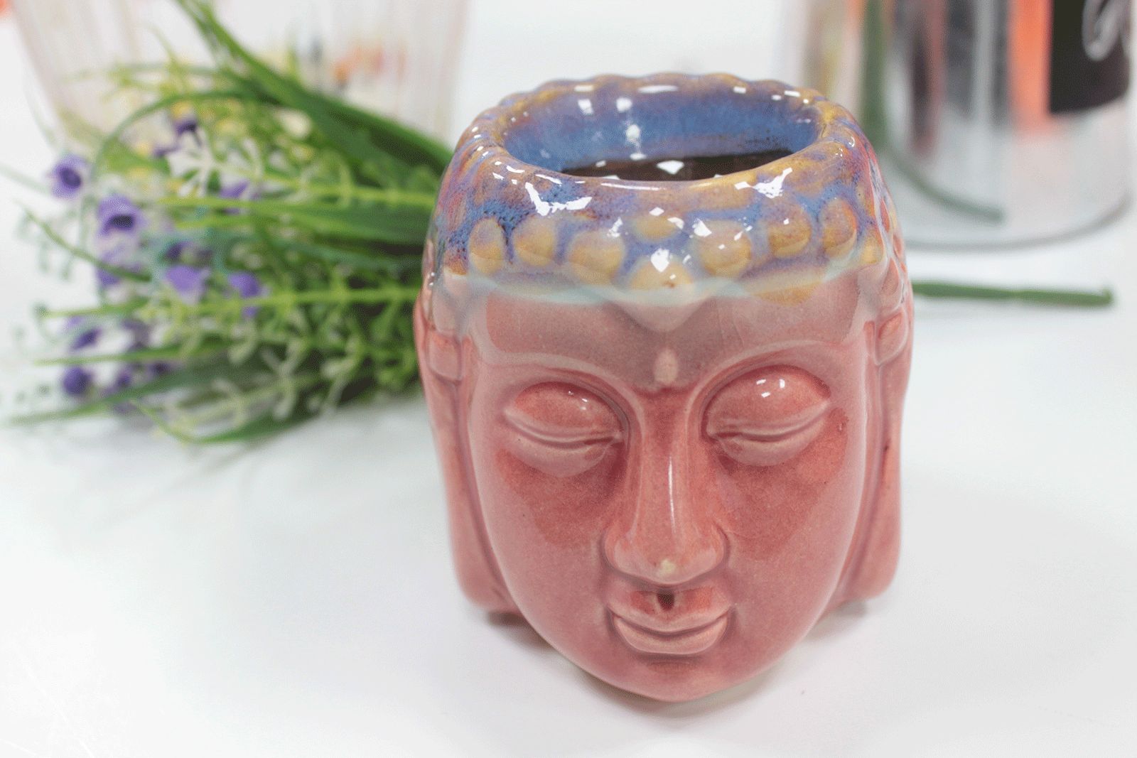 Ceramic face-shaped vase with a blurred background