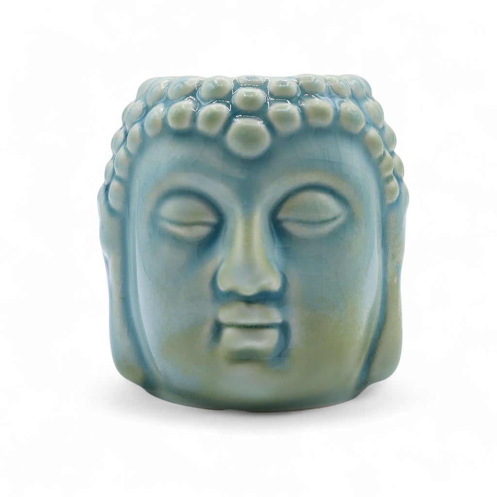 Ceramic Buddha head sculpture on a white background