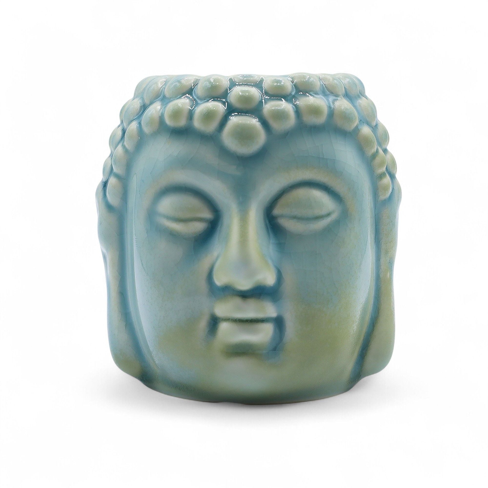 Ceramic Buddha head sculpture on a white background