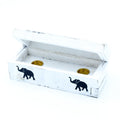 White wooden box with elephant designs on a white background