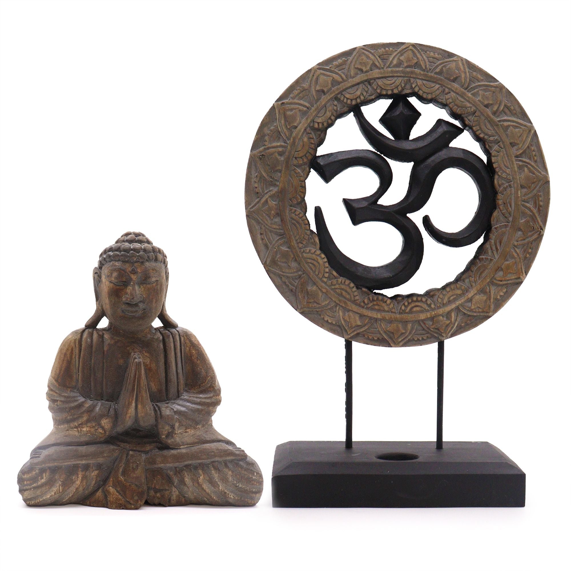 Wooden statue of a meditating Buddha figure with an Om symbol in the center on a white background