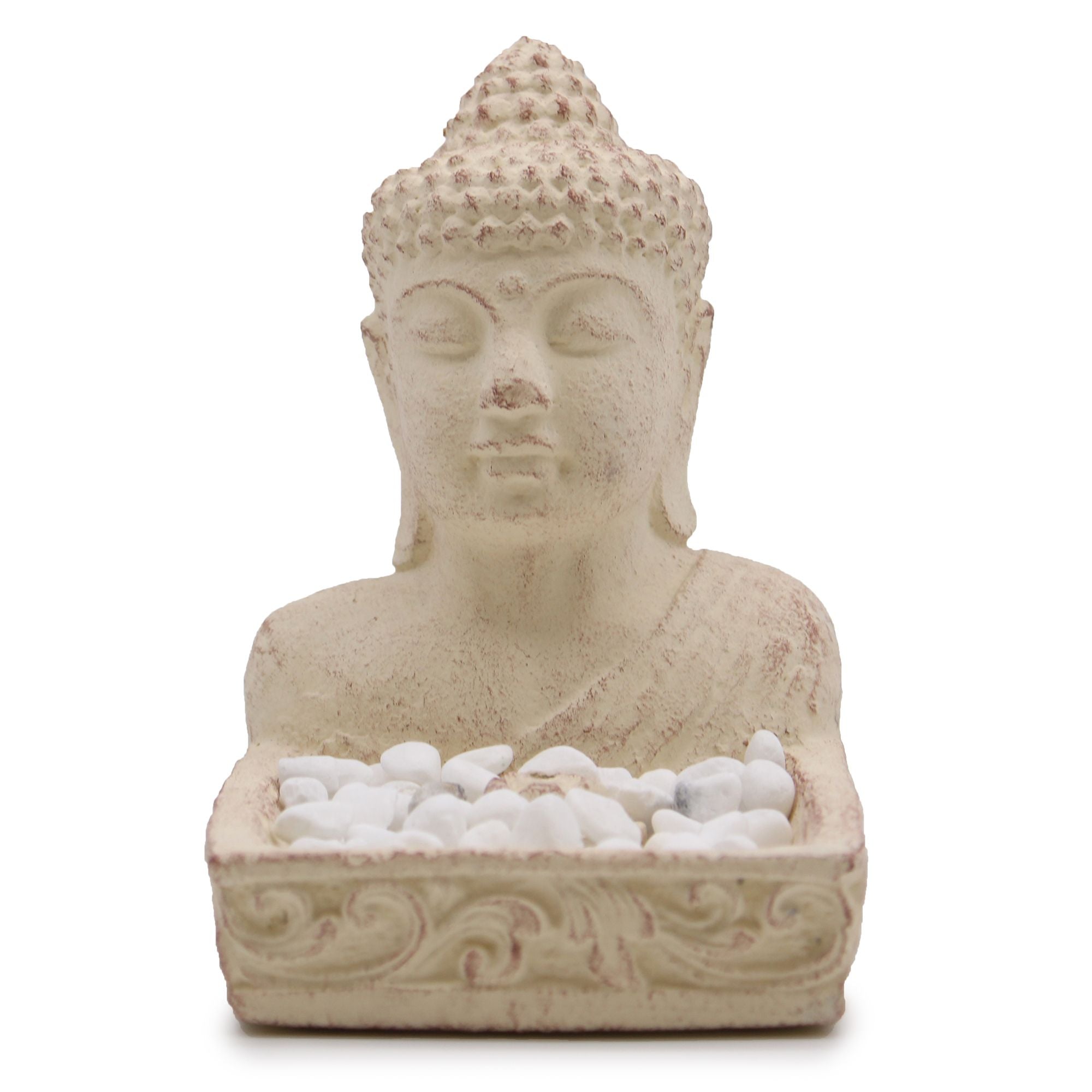 Stone Buddha bust with a small dish of white pebbles on a white background