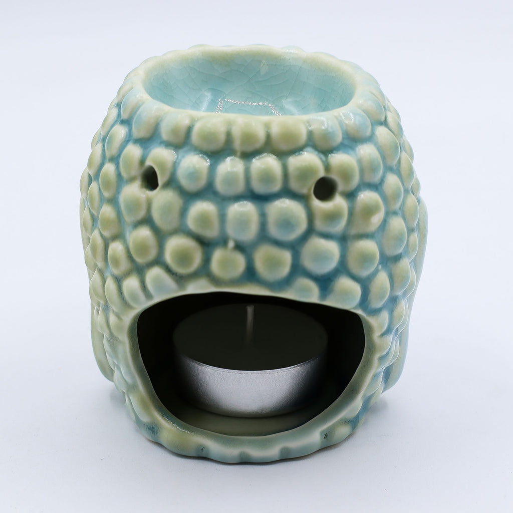 Ceramic tealight holder with textured surface on a white background