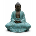 Statue of a meditating Buddha in turquoise robes on a white background